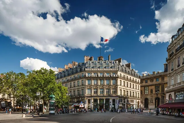 The Hotel du Louvre occupies a historic building beside the Louvre in a Parisian square.