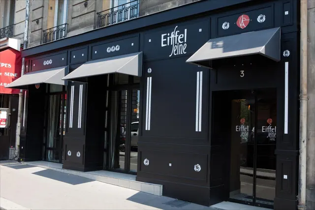 The Eiffel Seine hotel entrance is shown on a Paris street beneath black awnings.
