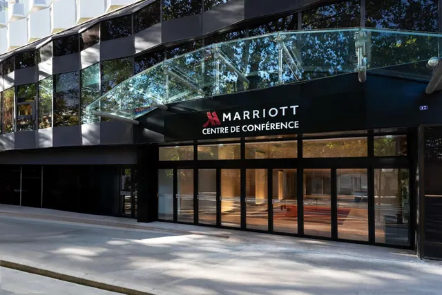 The Marriott conference centre entrance has a glass canopy and reflective dark facade.