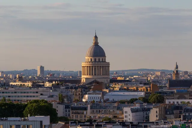 The Panthéon rises above the Paris skyline in the evening light.