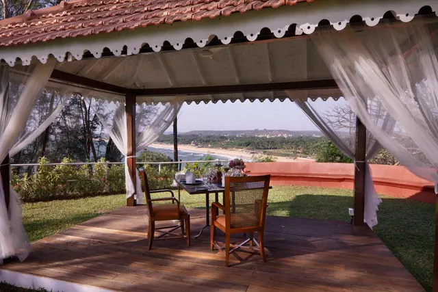 A covered outdoor dining terrace overlooks the beach and sea.